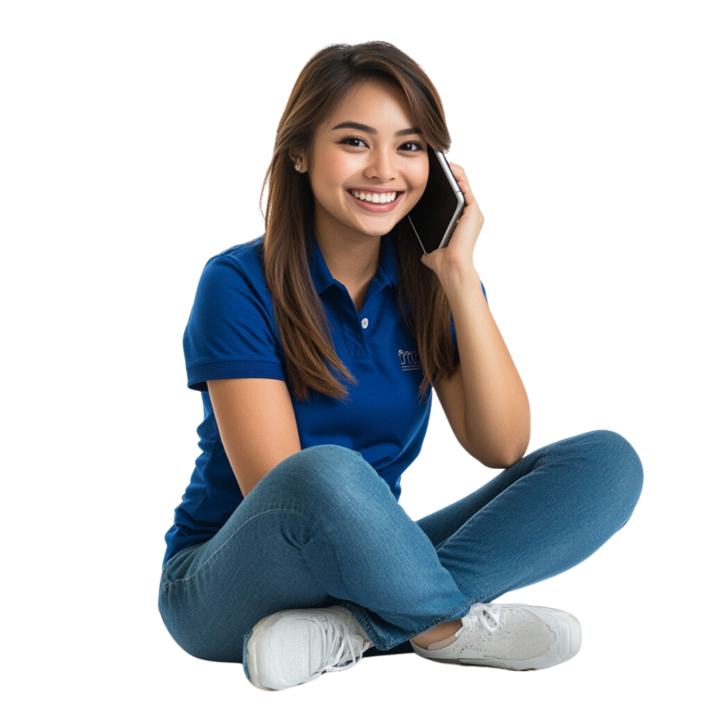 Smiling female customer support specialist seated while talking on the phone, wearing a blue Virtual Coworker polo shirt.